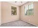 Comfortable bedroom featuring plush carpet, and two windows allowing for natural light at 15551 W Poinsettia Dr, Surprise, AZ 85379