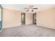 Spacious bedroom featuring neutral colors, soft carpet, and a ceiling fan at 15551 W Poinsettia Dr, Surprise, AZ 85379