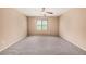 This cozy bedroom features neutral walls, carpet, and a window bringing in lots of light at 15551 W Poinsettia Dr, Surprise, AZ 85379