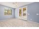 Bright dining room with tile flooring, chandelier, and patio access through double doors at 15551 W Poinsettia Dr, Surprise, AZ 85379