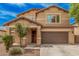 Charming two-story home featuring a well-manicured front yard, covered porch, and attached two-car garage at 15551 W Poinsettia Dr, Surprise, AZ 85379