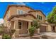 Charming two-story home featuring a well-manicured front yard, covered porch, and attached two-car garage at 15551 W Poinsettia Dr, Surprise, AZ 85379
