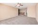 Cozy loft space with neutral walls, carpet, and a wooden staircase and railing at 15551 W Poinsettia Dr, Surprise, AZ 85379