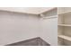 Organized walk-in closet with shelves and clothing rods at 15551 W Poinsettia Dr, Surprise, AZ 85379