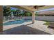 Lush backyard boasts a large pool, covered patio and serene setting at 1610 W Maplewood St, Chandler, AZ 85286