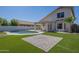 Expansive backyard with artificial turf, pool and brick patio, great for entertaining at 1610 W Maplewood St, Chandler, AZ 85286