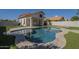 Backyard oasis featuring a pool, artificial grass and a patio to provide space for outdoor living at 1610 W Maplewood St, Chandler, AZ 85286