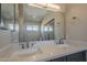 Bright bathroom features double sinks, quartz countertops, and a large mirror for a luxurious feel at 1610 W Maplewood St, Chandler, AZ 85286