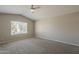 Spacious bedroom with carpet flooring, neutral walls, and a large window offering natural light at 1610 W Maplewood St, Chandler, AZ 85286