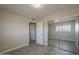 Bedroom features wood-look flooring, closet with mirrored doors and neutral paint for versatile decor at 1610 W Maplewood St, Chandler, AZ 85286