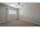 This bedroom showcases neutral carpet, bright lighting and a ceiling fan at 1610 W Maplewood St, Chandler, AZ 85286