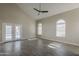 Bright living room with tile floors, double doors leading to the pool, and arched windows filling the space with light at 1610 W Maplewood St, Chandler, AZ 85286