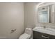 Charming powder room with a modern vanity, sleek toilet and a decorative mirror at 1610 W Maplewood St, Chandler, AZ 85286