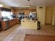 Spacious kitchen with stainless steel appliances, wood cabinets, tile floors and a kitchen island at 1623 E Fremont Rd, Phoenix, AZ 85042