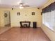 Open-concept living room featuring wood-laminate floors, ceiling fan, and bright neutral paint at 1623 E Fremont Rd, Phoenix, AZ 85042