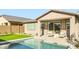 Beautiful backyard pool with a cozy seating area and lush green grass, perfect for outdoor relaxation and entertaining at 16714 W Audrey Ln, Surprise, AZ 85387