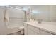 This bathroom features a sleek vanity, a tub with a shower, and modern fixtures at 16714 W Audrey Ln, Surprise, AZ 85387