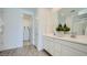 Bright bathroom featuring dual sinks, white cabinets, and a glass-enclosed shower, offering a clean and modern design at 16714 W Audrey Ln, Surprise, AZ 85387