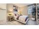 This bedroom showcases neutral colors, a large window, and comfortable decor, with a walk-in closet at 16714 W Audrey Ln, Surprise, AZ 85387