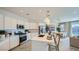 Modern kitchen featuring a spacious island, stainless steel appliances, and stylish pendant lighting at 16714 W Audrey Ln, Surprise, AZ 85387