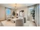 Stylish living room with contemporary furniture, neutral tones, and plenty of natural light for a cozy atmosphere at 16714 W Audrey Ln, Surprise, AZ 85387