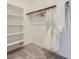 Bright walk-in closet boasts built-in shelving and ample hanging space for organized storage at 16714 W Audrey Ln, Surprise, AZ 85387