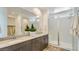 Bright bathroom with double sinks, a walk-in shower, and contemporary finishes at 16739 W Charlotte Dr, Surprise, AZ 85387