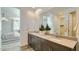 Modern bathroom featuring double sinks, a large mirror, and contemporary fixtures at 16739 W Charlotte Dr, Surprise, AZ 85387