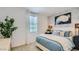 A cozy bedroom with a decorative basketball hoop art piece and an abundance of natural light from the window at 16739 W Charlotte Dr, Surprise, AZ 85387