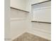 Walk-in closet with carpet flooring and shelving racks for organized storage at 16739 W Charlotte Dr, Surprise, AZ 85387
