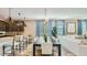 Open dining area features a long table, modern lighting, and easy access to the kitchen at 16739 W Charlotte Dr, Surprise, AZ 85387
