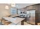 Modern kitchen with stainless steel appliances, gray cabinets, quartz countertops and pendant lighting at 16739 W Charlotte Dr, Surprise, AZ 85387