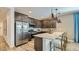 Modern kitchen boasts stainless steel appliances, a large island with seating, and sleek cabinetry at 16739 W Charlotte Dr, Surprise, AZ 85387