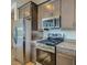 This kitchen is equipped with stainless steel appliances and offers a functional layout at 16739 W Charlotte Dr, Surprise, AZ 85387