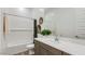 A well-lit bathroom features a tub, shower, white countertops, and gray cabinets at 16933 W Bronco Trl, Surprise, AZ 85387