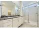 Bathroom featuring granite counters, double sinks, and a glass enclosed shower at 16933 W Bronco Trl, Surprise, AZ 85387