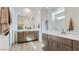 Luxurious bathroom featuring dual vanities, a spacious shower, and modern design at 16933 W Bronco Trl, Surprise, AZ 85387