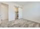 Carpeted bedroom featuring laundry area behind a modern sliding door at 16933 W Bronco Trl, Surprise, AZ 85387