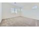Spacious carpeted bedroom with ample natural light from multiple windows at 16933 W Bronco Trl, Surprise, AZ 85387