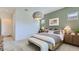 Stylish bedroom featuring a decorative light fixture, neutral tones, and carpeted floors at 16933 W Bronco Trl, Surprise, AZ 85387