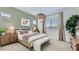 Comfortable bedroom with large windows, wooden furniture, and a cozy seating bench at 16933 W Bronco Trl, Surprise, AZ 85387