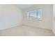 Minimalist bedroom featuring neutral walls, tile flooring, and a large window for natural light at 16933 W Bronco Trl, Surprise, AZ 85387