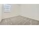 This bedroom features neutral carpeting and a window for ample natural light at 16933 W Bronco Trl, Surprise, AZ 85387