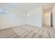 Bright bedroom featuring neutral carpet, white walls, and natural light from a window at 16933 W Bronco Trl, Surprise, AZ 85387