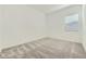 This bedroom features neutral carpeting and a window for ample natural light at 16933 W Bronco Trl, Surprise, AZ 85387