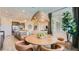 Bright dining room showcases a woven light fixture, round table, and six chairs, perfect for entertaining at 16933 W Bronco Trl, Surprise, AZ 85387