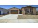 Charming single-story home featuring a two-car garage, desert landscaping, and a welcoming entrance at 16933 W Bronco Trl, Surprise, AZ 85387