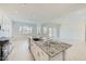 Bright, airy kitchen showcasing a granite island with seating, and stainless steel appliances at 16933 W Bronco Trl, Surprise, AZ 85387