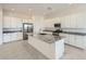 Bright kitchen featuring white cabinets, granite countertops, stainless steel appliances, and an island with a sink at 16933 W Bronco Trl, Surprise, AZ 85387