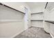 Walk-in closet with carpeted floor, white walls, and shelving at 16933 W Bronco Trl, Surprise, AZ 85387